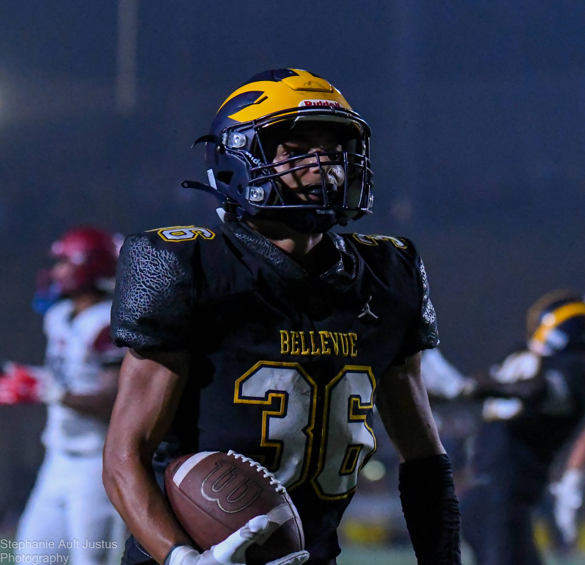 Nick Simms from Bellevue High makes a thrilling touchdown run during the heated match against Bethel.